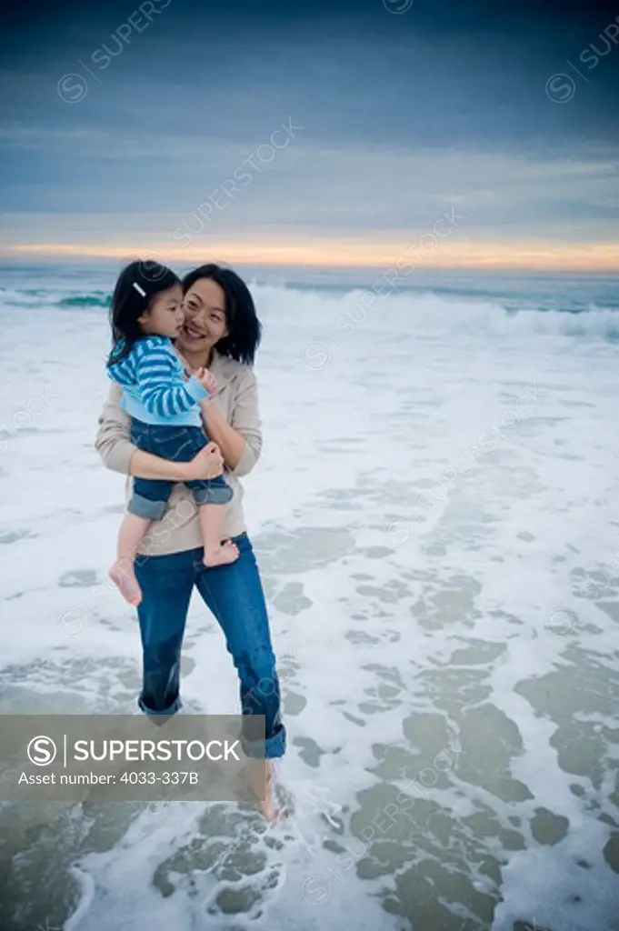 Mid adult woman enjoying with her daughter on the beach, La Jolla, California, USA