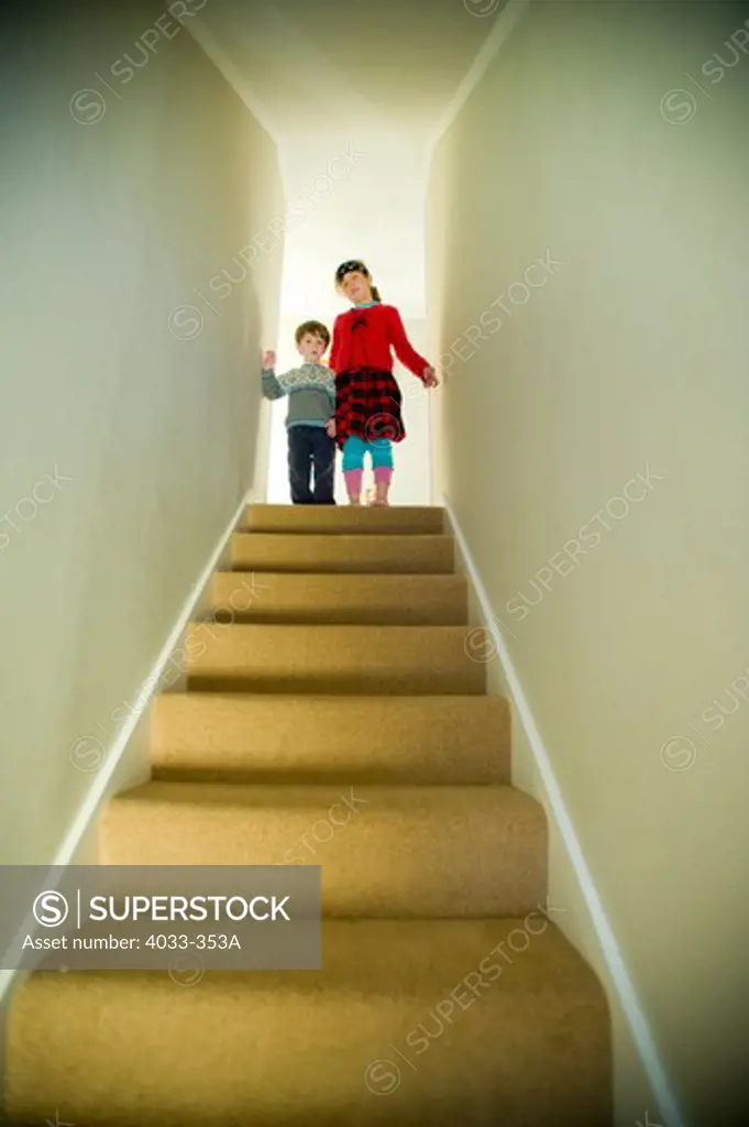 Low angle view of a boy and a girl on the top of the staircase, Ithaca, New York State, USA