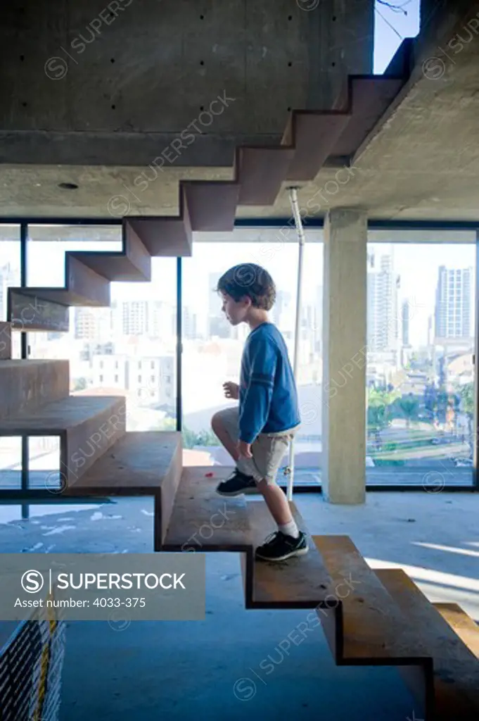 Boy walking up stairs, San Diego, California, USA