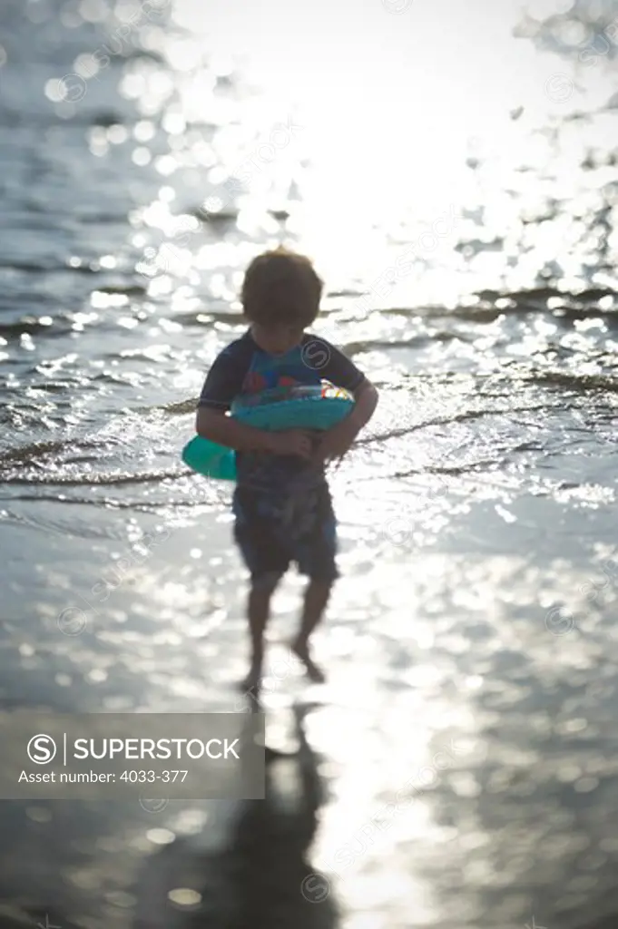 Boy playing on the beach, San Diego, California, USA