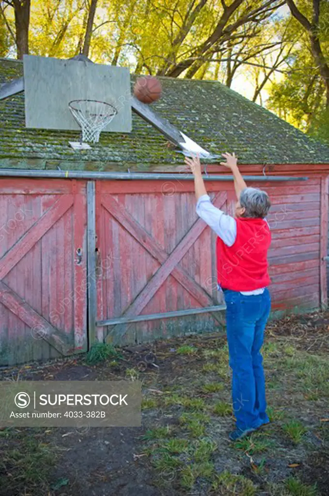 Mature woman playing basketball, Bozeman, Montana, USA