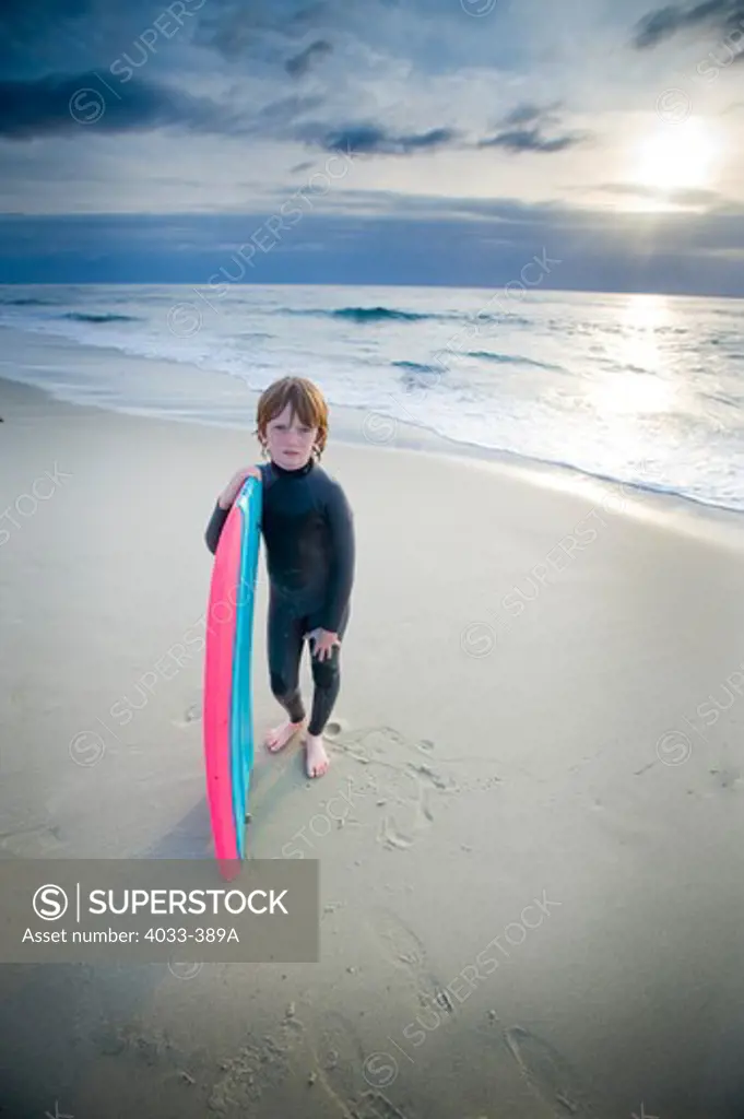 Boy with a bodyboard on the beach, San Diego, California, USA