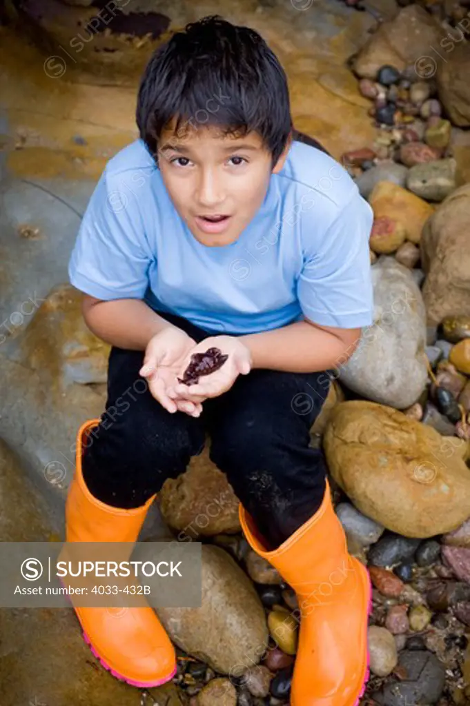 Boy with a sea slug in his hands