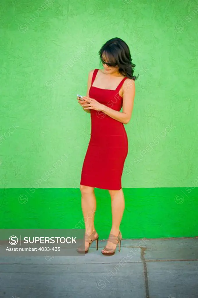 Mid adult woman text messaging on a mobile phone