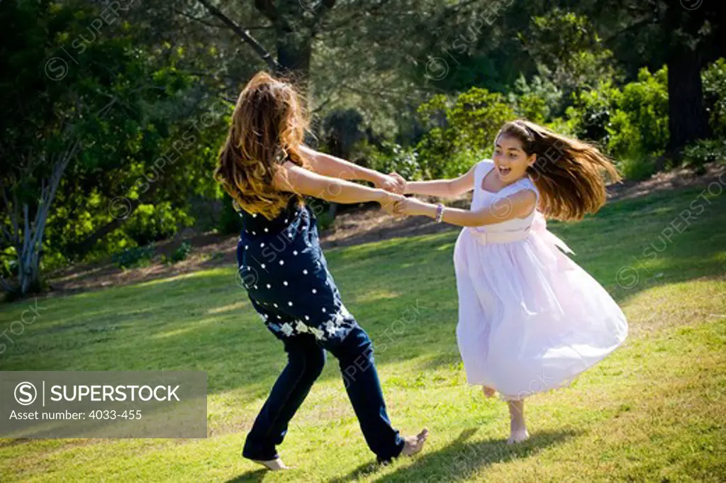 Mid adult woman playing with her daughter in a park