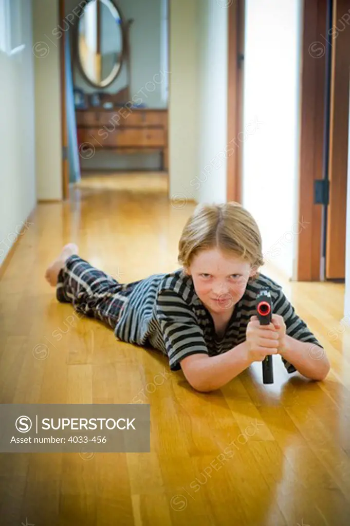 Boy playing with a toy gun