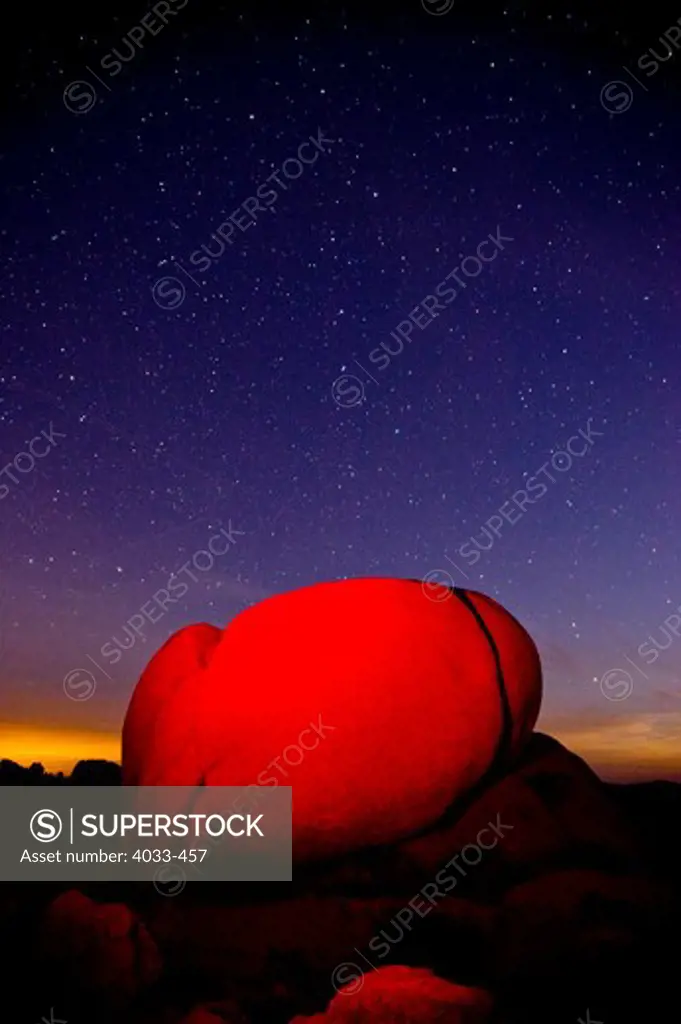 Red light on a boulder at night, Joshua Tree National Monument, California, USA