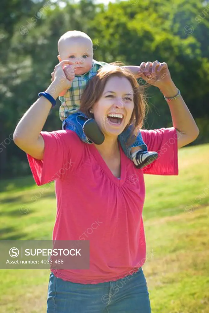 Young woman playing with her son in a park