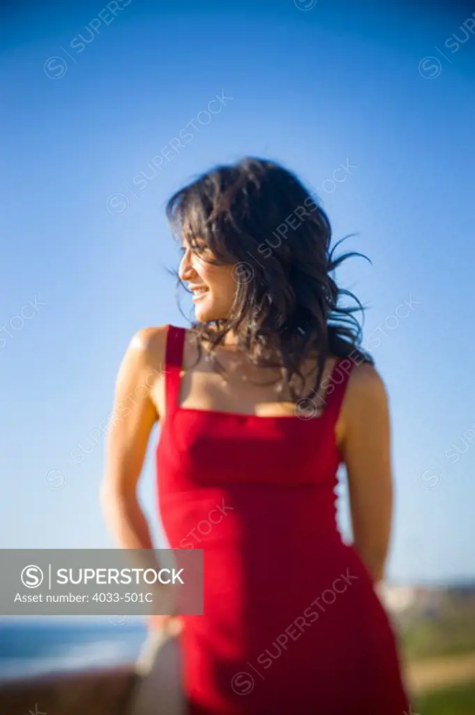 Mid adult woman standing on the beach looking at sea view
