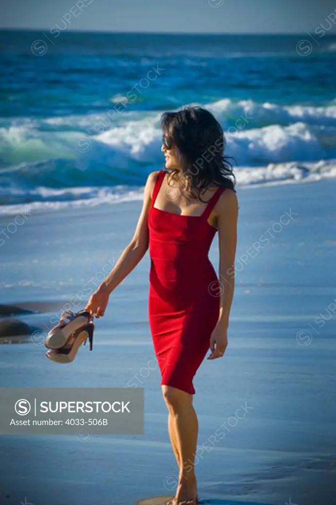 Mid adult woman walking on the beach