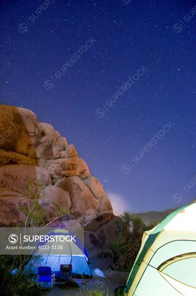 Dome tents lit up at night, Joshua Tree National Monument, California, USA
