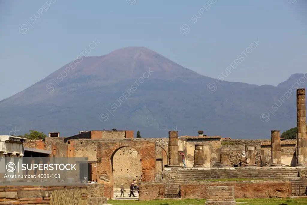 Ruins of buildings with a volcanic mountain in the background, Pompei, Mt Vesuvius, Naples, Campania, Italy