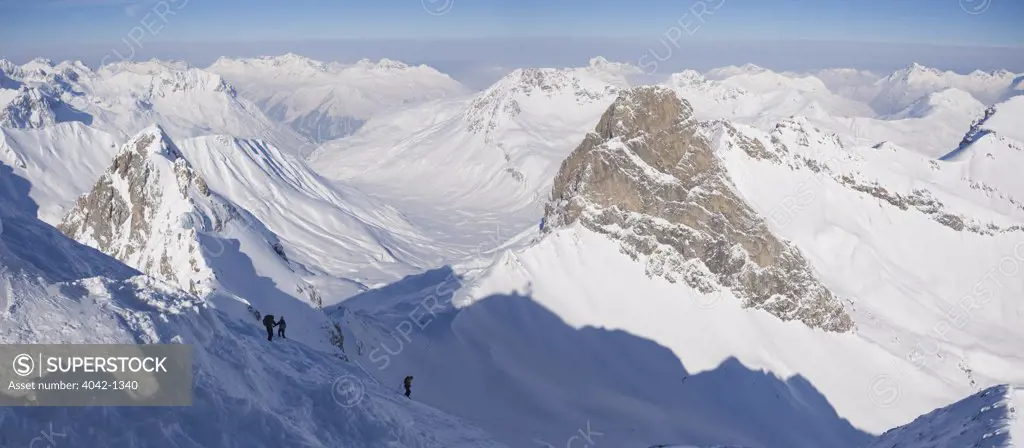 Tourists skiing on snow covered mountains, Valluga, Sankt Anton am Arlberg, Austrian Alps, Tyrol, Austria