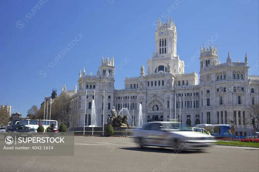 Traffic at a town square with a palace, Palacio De Comunicaciones, Plaza De Cibeles, Madrid, Spain