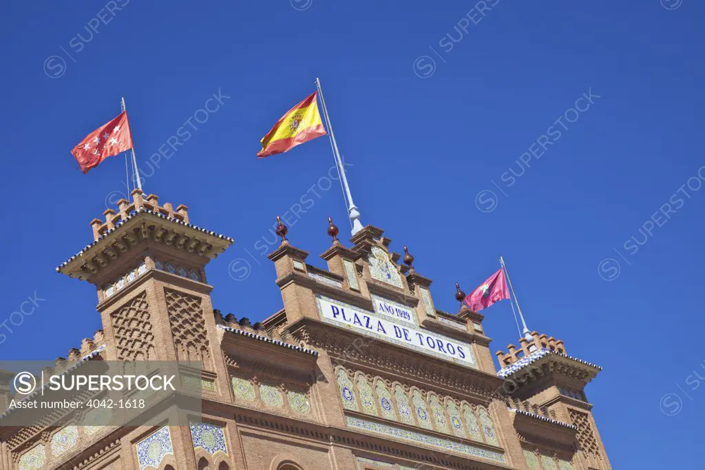 Low angle view of Spanish flags on Puerta Grande, Las Ventas Bullring, Madrid, Spain