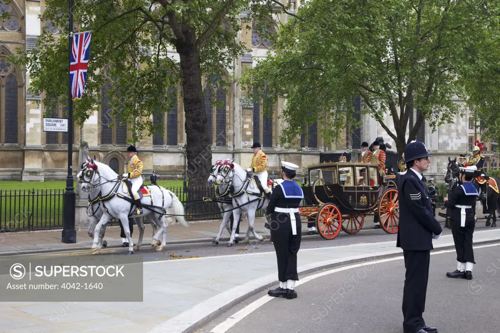 Four Windsor grey horses pulling the Scottish state coach which carries Queen Elizabeth II and the Duke of Edinburgh outside of Westminster Abbey for participating in marriage of Prince William to Kate Middleton on 29th April 2011, London, England