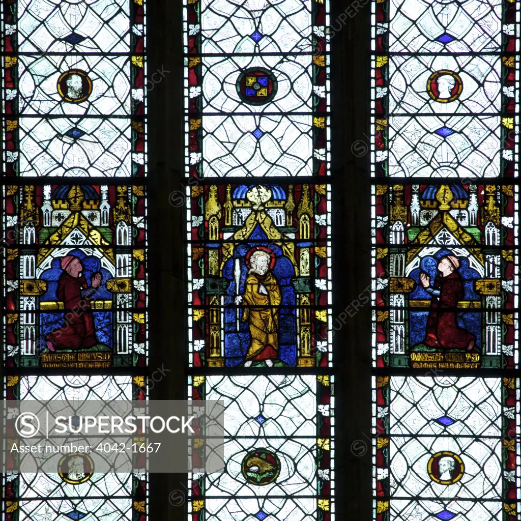 England, Oxfordshire, Oxford, Oxford University, Merton College Chapel, 13th and 14th Century stained glass windows, Saint with kneeling patrons