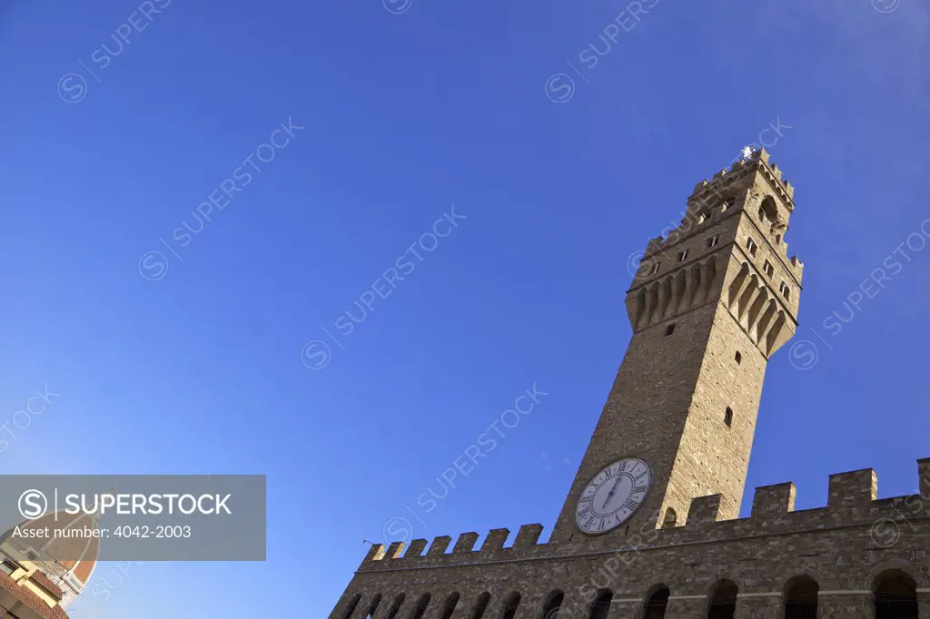 Low angle view of Duomo Santa Maria Del Fiore and clock tower of Palazzo Vecchio, Piazza della Signoria, Florence, Tuscany, Italy