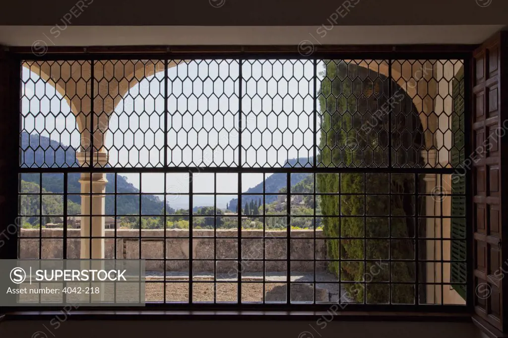 Mountains viewed through the window of a monastery, Valldemossa Charterhouse, Valldemossa, Majorca, Balearic Islands, Spain