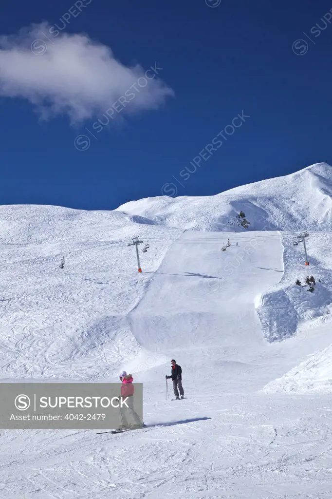 Skiers on Bozelet blue piste in winter sunshine, Verdons Sud, La Plagne, Rhone-Alpes, France