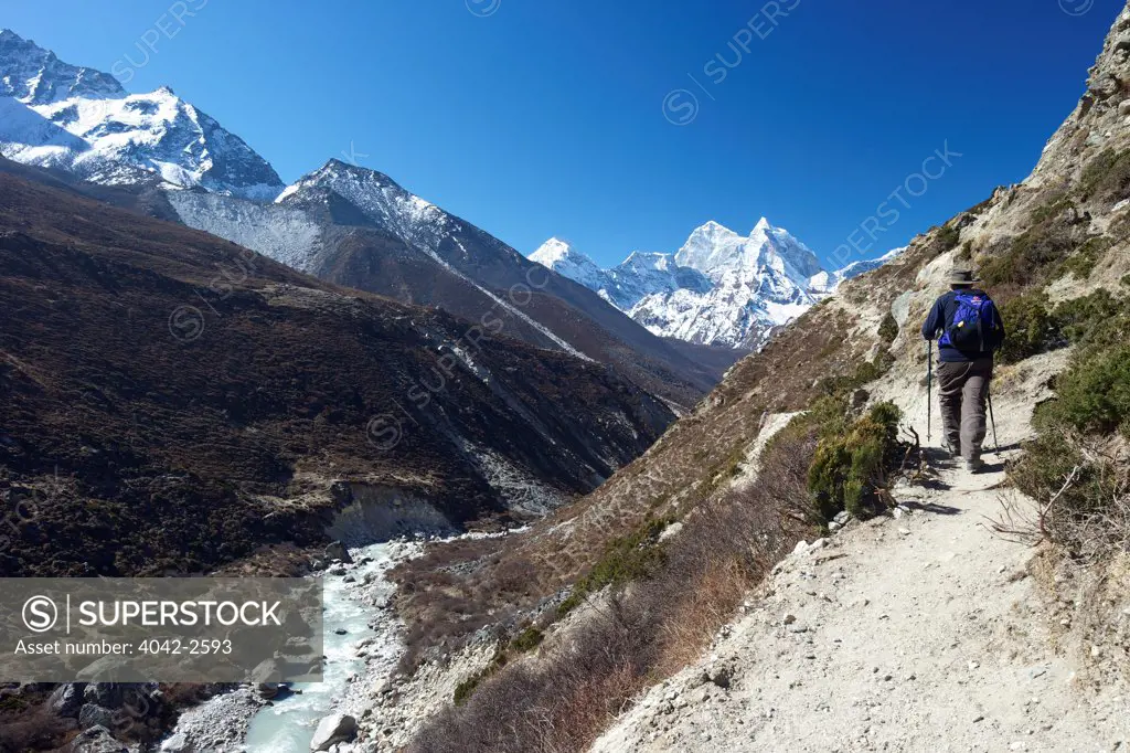 Trekker on Pheriche Pass with Ama Dablam in distance, Sagarmatha National Park, Solukhumbu District, Nepal