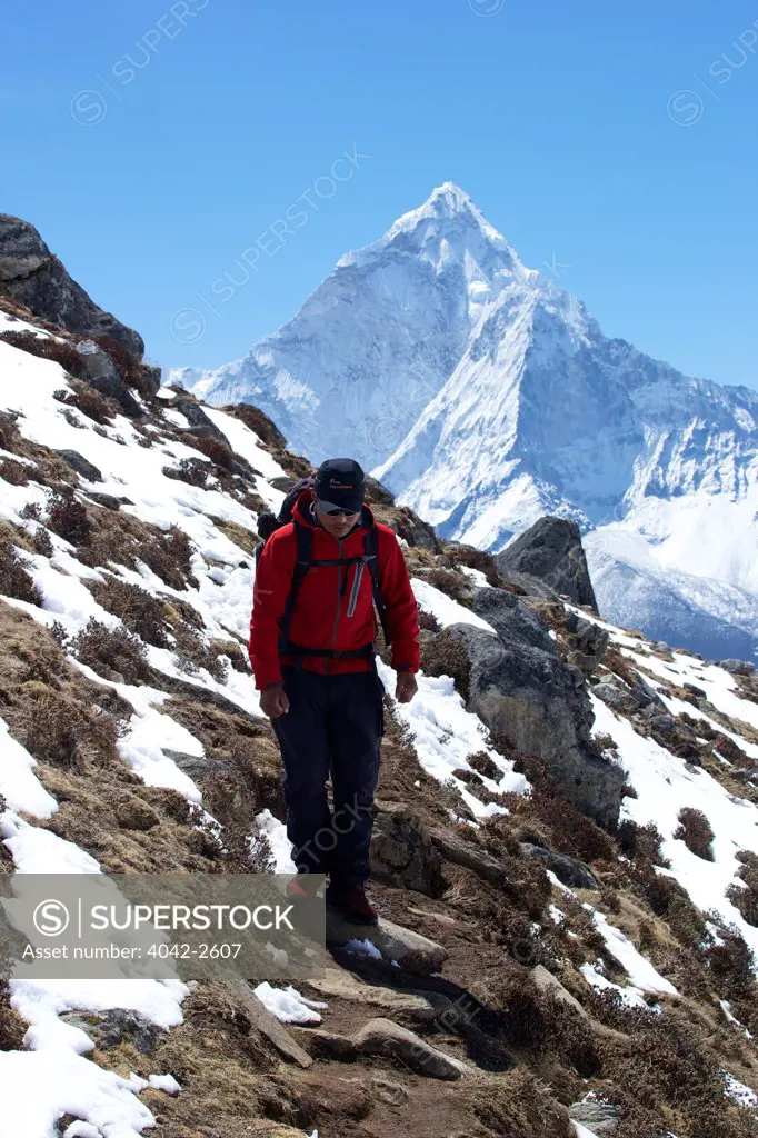 Trekker in Chola Khola valley near Dzonglha with Ama Dablam, Solukhumbu District, Sagarmatha National Park, Nepal