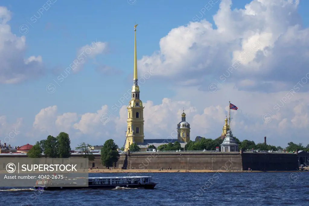 Tourist boat on the Neva River in front of the Peter and Paul Fortress and the Peter And Paul Cathedral, St. Petersburg, Russia