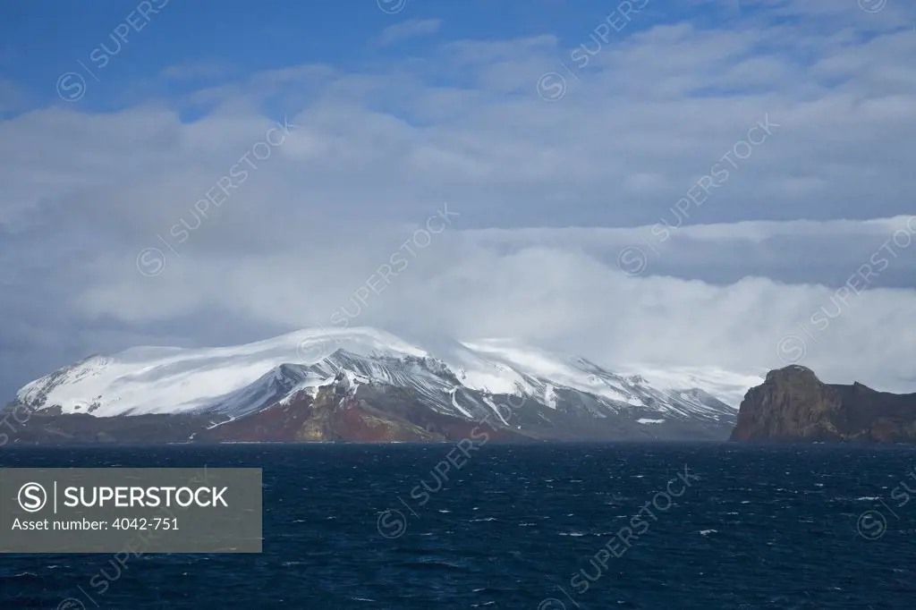 Clouds over snowcapped mountains, Neptune's Bellows, Deception Island, South Shetland Islands, Antarctica