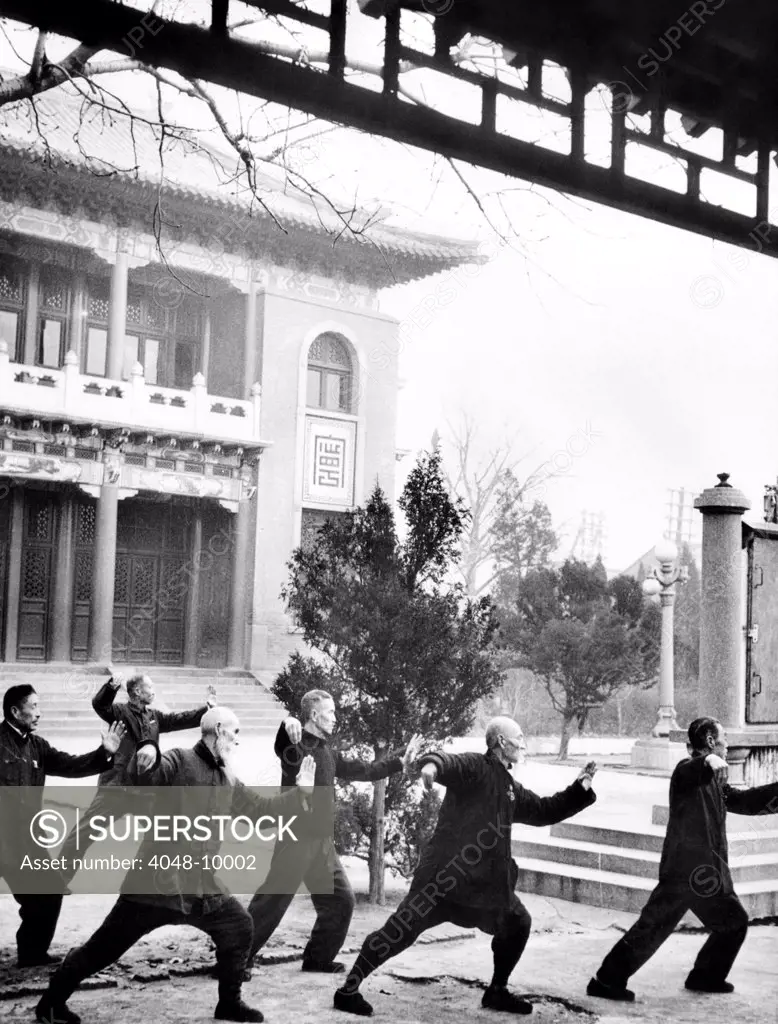 Middle-aged Chinese men practice T'ai chi in Hopei Province, Communist China. Jan. 1962.