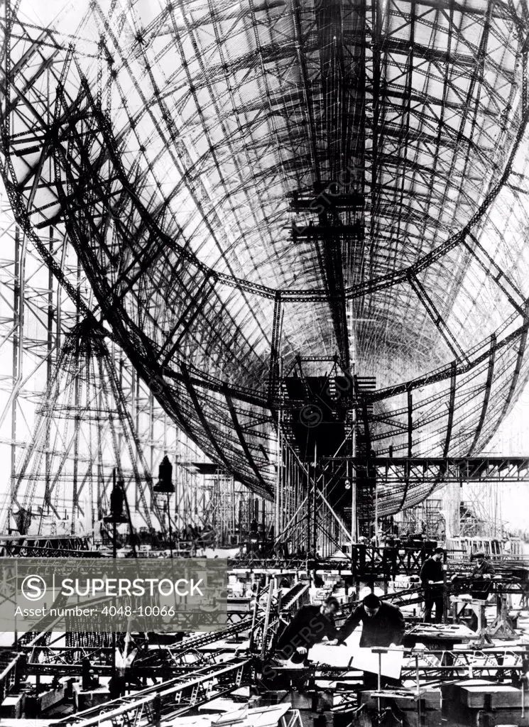 Hindenburg Airship under construction. The almost complete steel frame at the Zeppelin works at Friedrichshafen, Germany. Mechanics work in the right foreground. Nov. 24, 1934.