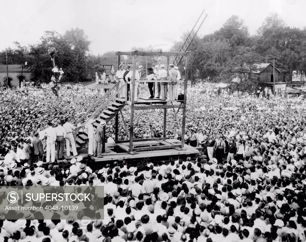 Thousands witness the public hanging of African American, Rainey Bertha, age 22. Bethea was convicted of raping, strangling, and robbing wealthy 70-year-old Elza Edwards on July 7, 1936. Owensboro, Kentucky. Aug. 14, 1936.