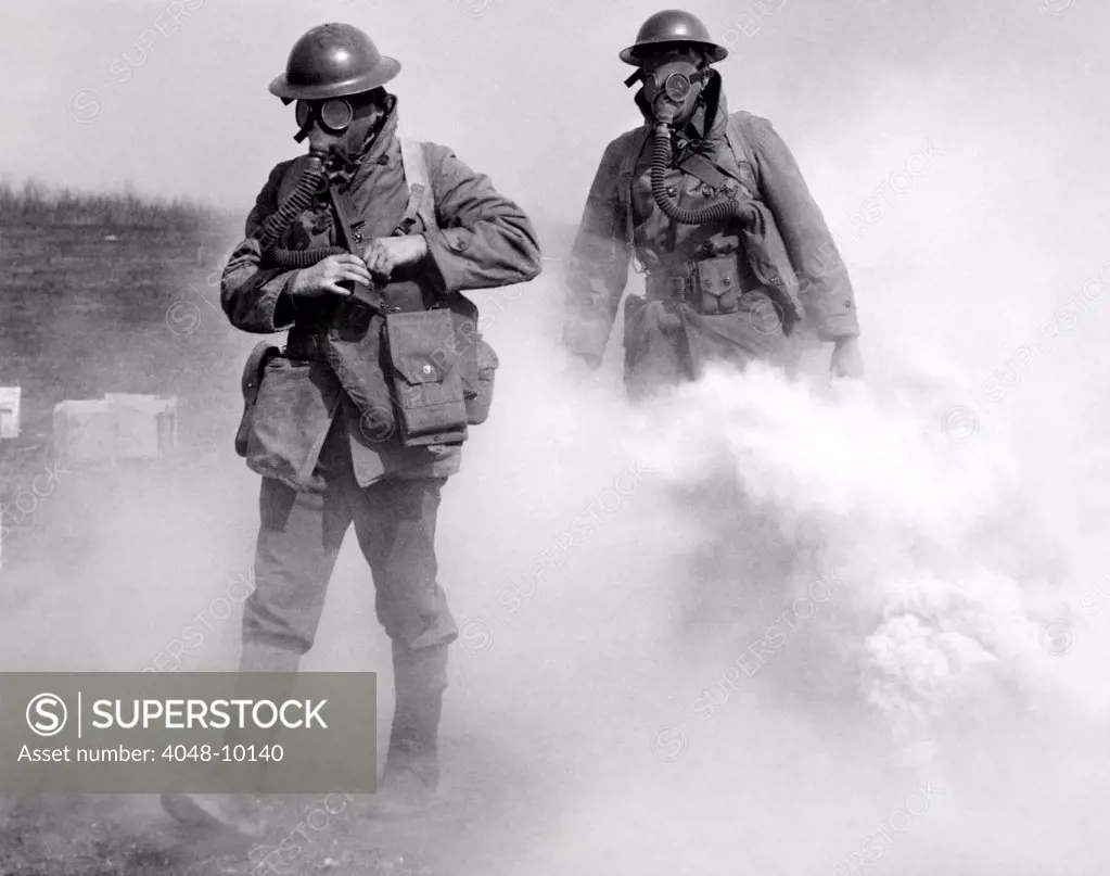 Gas masked soldier walk through an actual gas attack during training. Edgewood, Maryland. April 7, 1939.