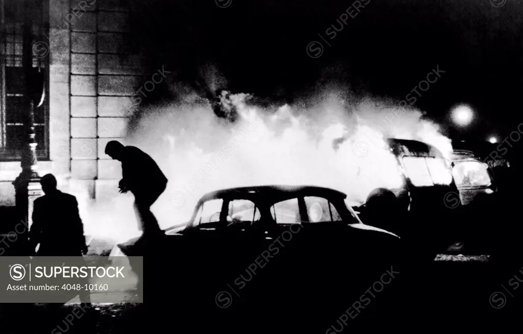 Demonstrators flee as a flaming police van illuminates the Latin Quarter, Paris. The protest began in response to the drowning of a student in the Seine River during clash with police June 10, 1968, the first day of France's national election campaign. June 11, 1968.