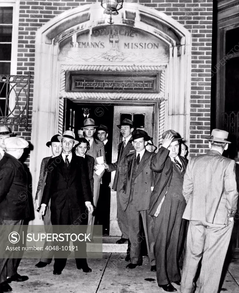 German aliens leaving the Deutsche Seaman Mission on Hudson Street for Ellis island in the custody of U.S. Immigration Service agents. They were unable to work for their employers after war broke out in Europe. May 7, 1941.