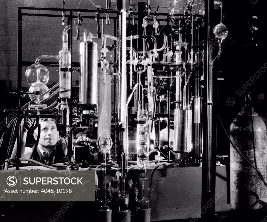 Industrial chemist among glass tubes in a laboratory. Feb. 1943.