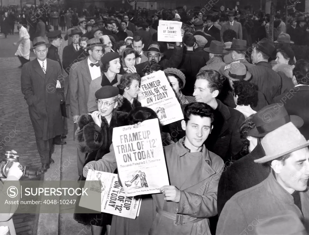 Communist Party members display the headlines of the 'Daily Worker', which reads. 'Frame Up Trial of '12' on Today.' June 1949.