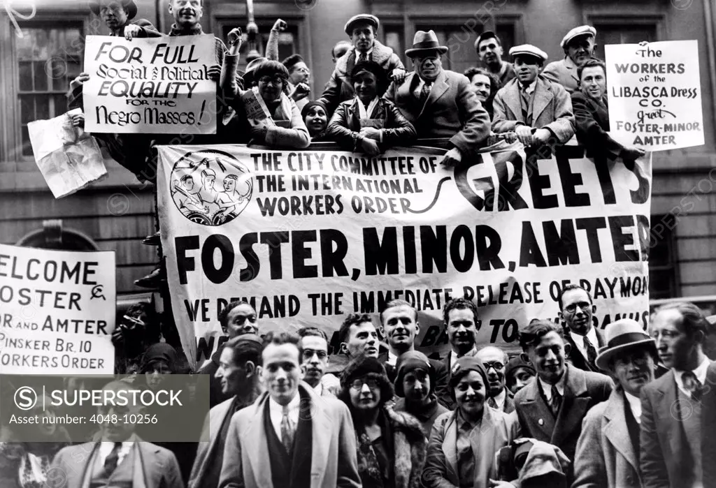 Communist mass meeting in New York City. A truck and individuals display signs welcoming leaders Israel Amter and William  Poster after their release from jail. Another reads, 'For Full Political and Social Equality for Negro Masses'. Oct. 21, 1930
