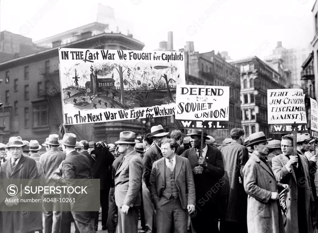 Communists with signs in Union Square on May Day, 1931. Signs read, 'In the Last War We Fought For Capitalism. In the Next War We Will Fight for the Working Man', and 'Defend the Soviet union'.