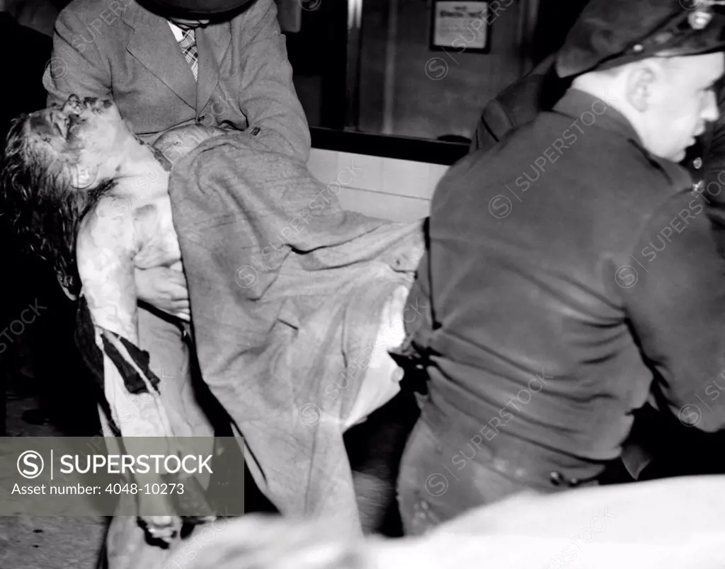 Coconut Grove Nightclub Fire. The body of a young female victim is removed from the nightclub. Nov. 28, 1942.