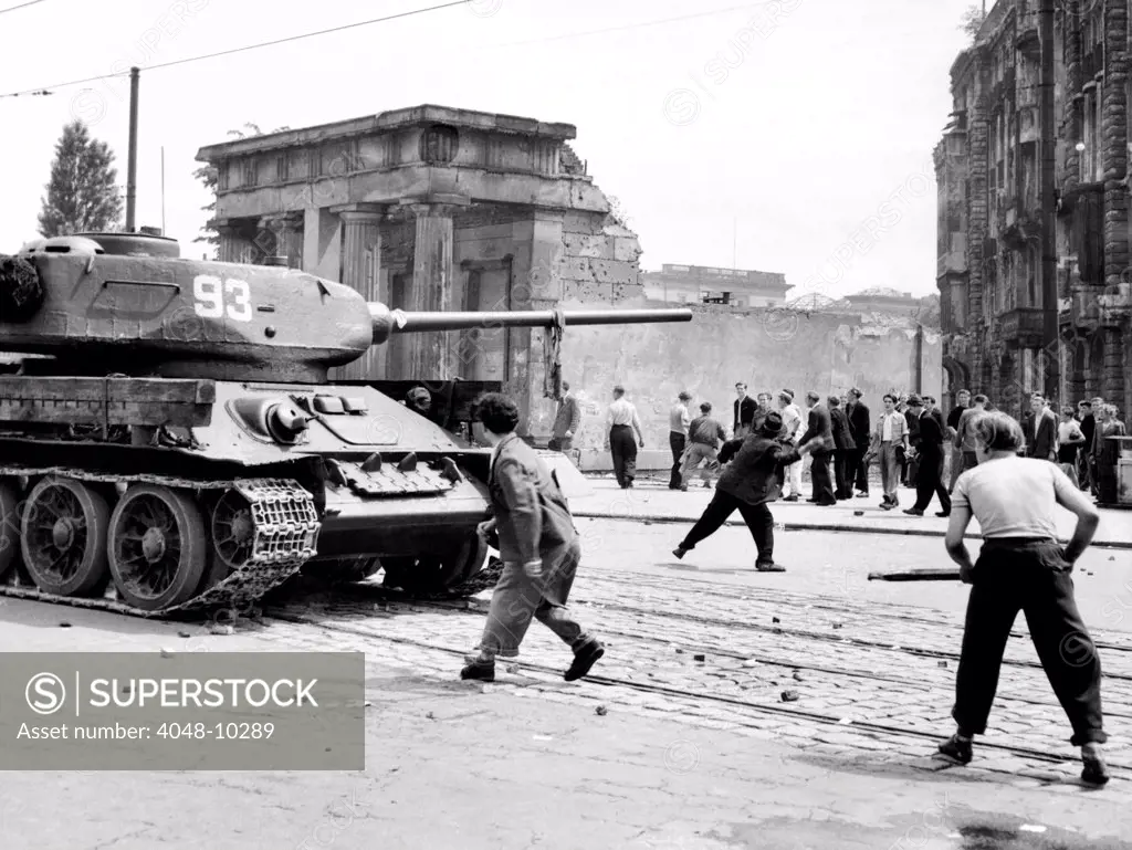 Anti-Communist riots in East Germany. An East Berliner throws stones at a Russian tank during the first violent resistance in a Soviet post war satellite state. It began with workers' strike over increased production targets and turned into widespread protests against the East German state. June 17, 1953.