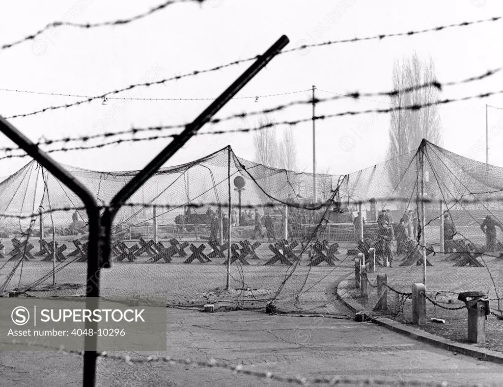 East Germany reinforces the concrete Berlin Wall. More barbed was strung on top of the wall. Steel girders in the ground and heavy netting form tank traps to protect against armored assault from the West. Nov. 20, 1961.