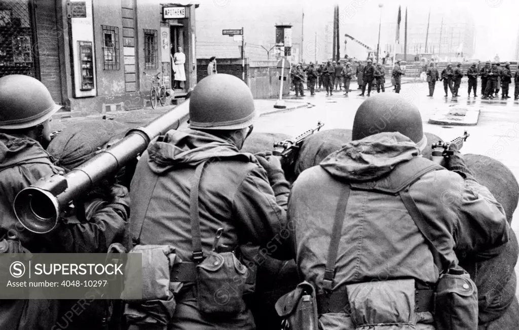 American troops face East Berlin behind sandbags at Checkpoint Charlie at Friedrichstrasse in West Berlin.  In the distance are East German soldiers. Dec. 4, 1961.