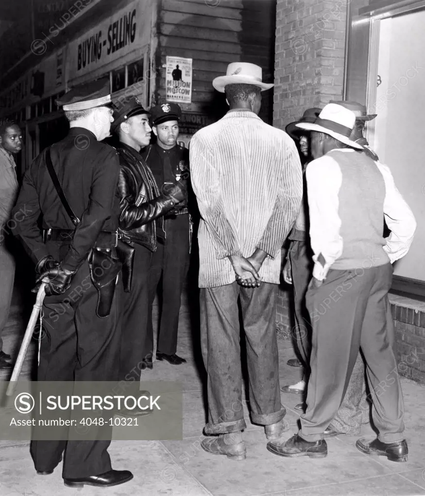 Zoot Suit Riots in Los Angeles. Police examine the draft credentials of some African American men. June 11, 1943.