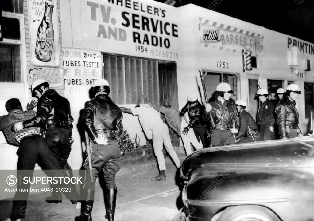 March 1966 Watts Riot. Police search African American youths in Watts During the second race riot in eight months. Two persons were killed, 25 injured and 31 persons were arrested during the shooting, 1ooting, burning, and beating. March 15, 1966.