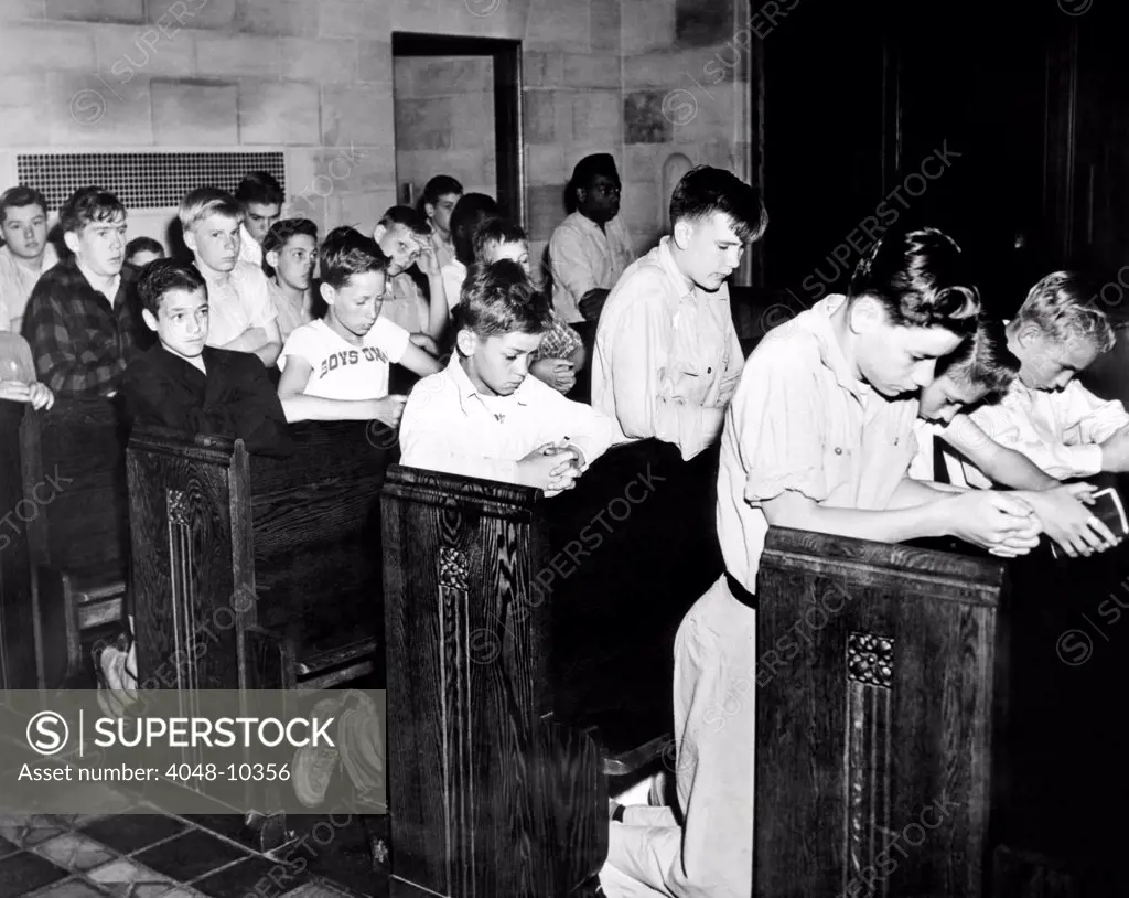 Boys Town citizens bow their heads in prayer for the Father Flanagan. Founder of Boys Town died recently In Germany while inspecting European youth organizations. May 15, 1948.