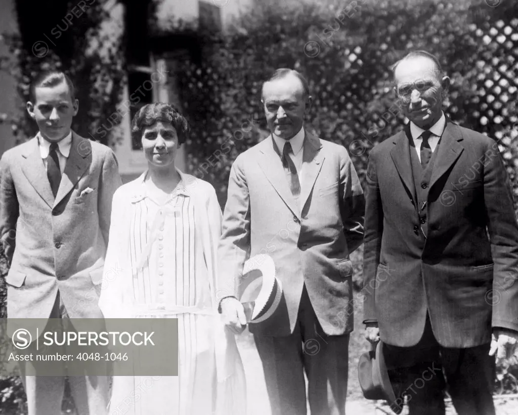 John Coolidge, Grace Coolidge, President Calvin Coolidge and Col. John Coolidge walking on the White House grounds, circa 1923