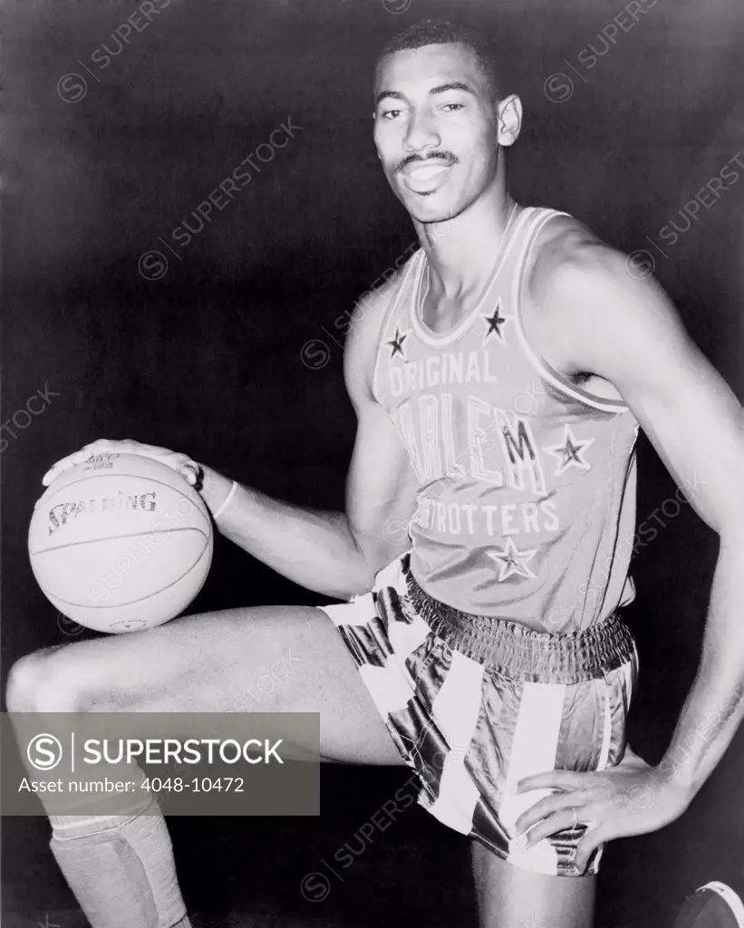 Wilt Chamberlain, wearing uniform of Harlem Globetrotters basketball team. 1959.