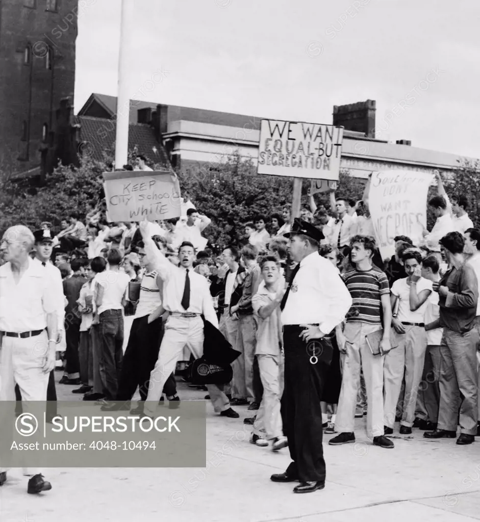 White teen-agers at Baltimore's City Hall in protest against school integration. One of their signs reads, 'Southern don't want Negroes'. 1955.