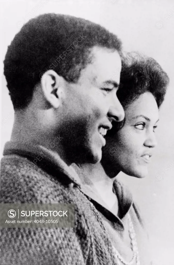 Hamilton Holmes and Charlayne Hunter laugh during a news interview after a court order struck down their suspension from the University of Georgia 'for their own safety.' Jan. 1961.