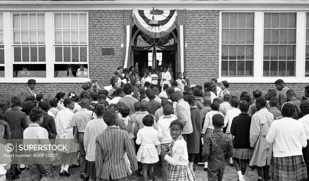 African American children entering the Mary E. Branch School in Farmville, Prince Edward County, Virginia on Sept. 16. 1963. The County closed its public schools for five years (1959-64) to evade court ordered integration. In 1963, a federally supported Prince Edward County Free School System opened four schools, including Mary E. Branch Elementary School. In 1964 the US Supreme Court ruled in Griffin v. County School Board of Prince Edward, ordered the schools be reopened.